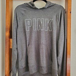 Pink athletic pullover with thumb holes and hood.